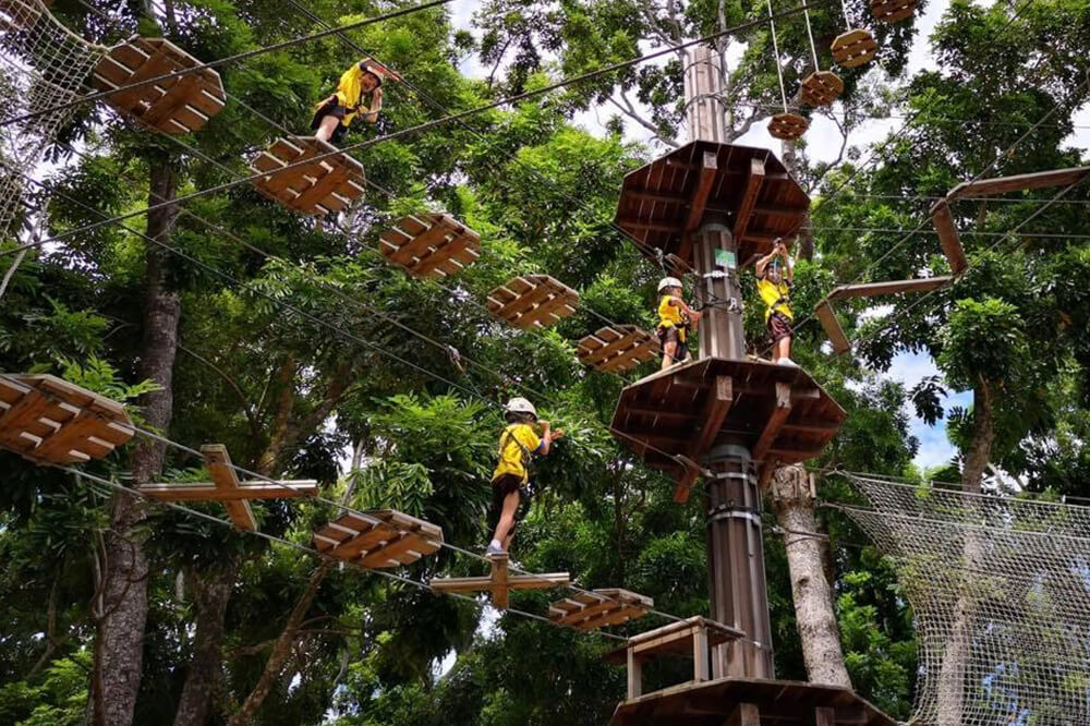 Pint-sized adventurers taking on the obstacle course in Forest Adventure in Singapore.